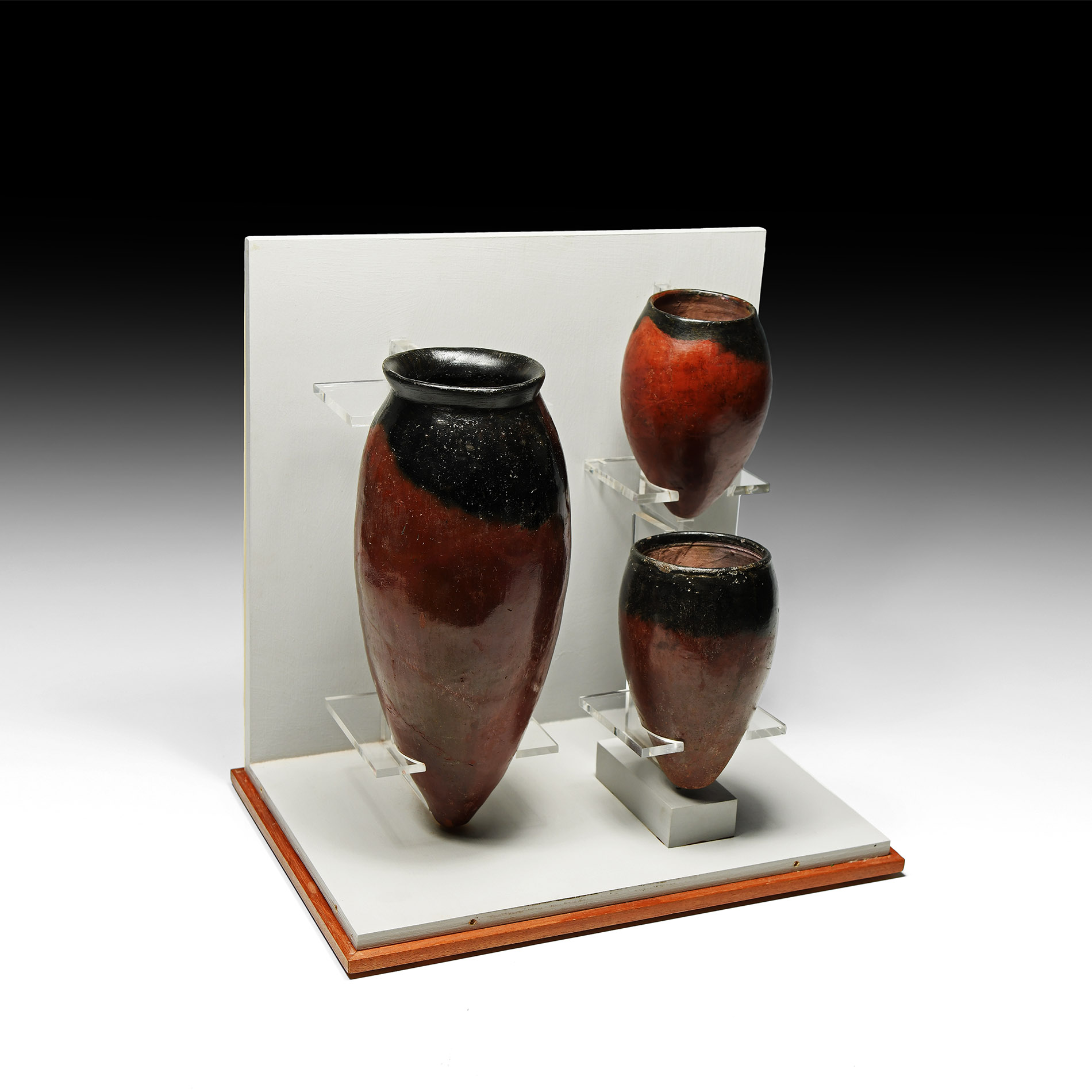 A group of three Egyptian black-topped pottery jars, Predynastic period