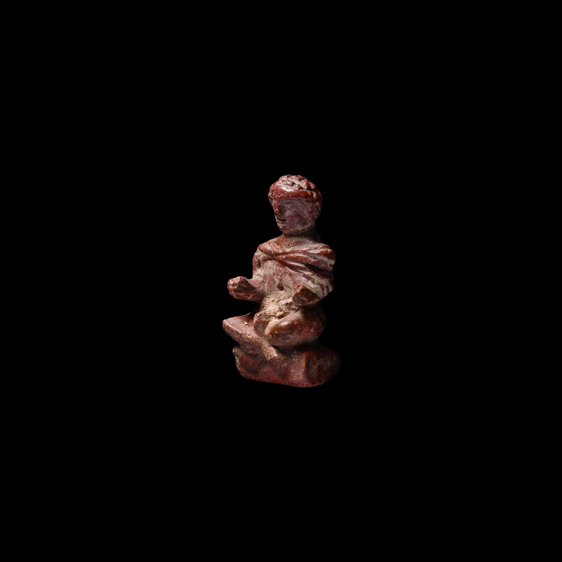 Late Roman Glass Pendant of a Seated Cloaked Male
