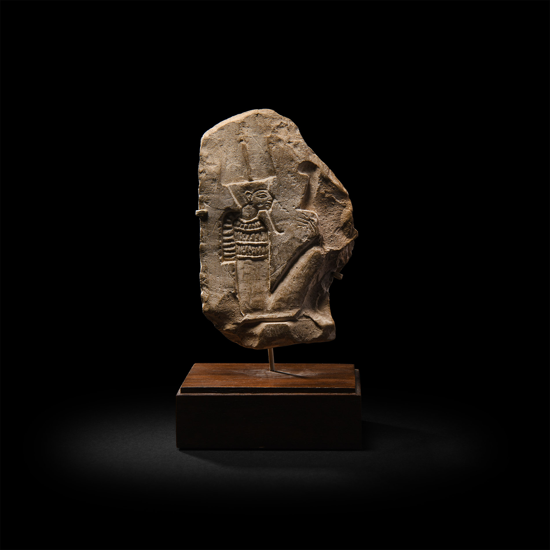 Egyptian Limestone Fragment with Seated God