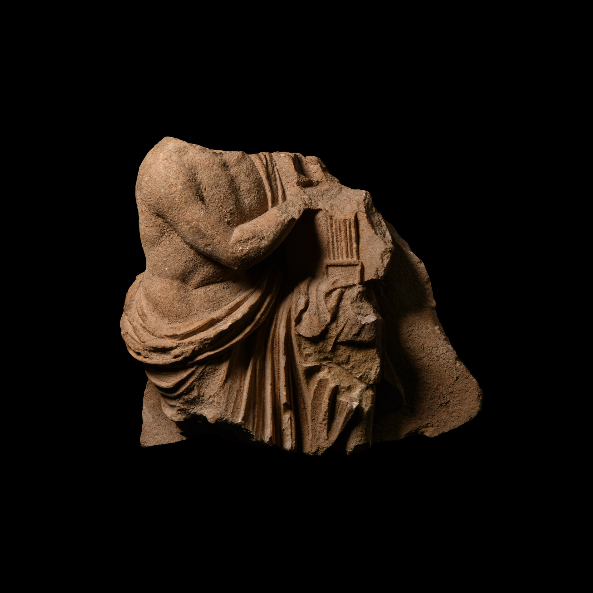 Roman Limestone Fragment of Draped Musician