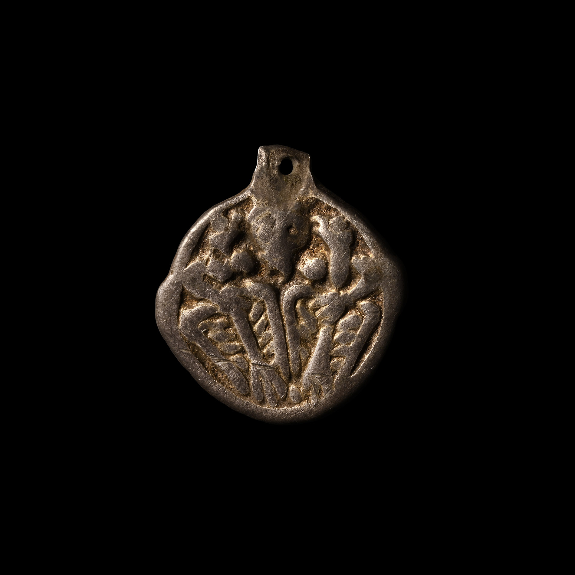 Viking Silver-Gilt Pendant with Odin Gripping Two Ravens