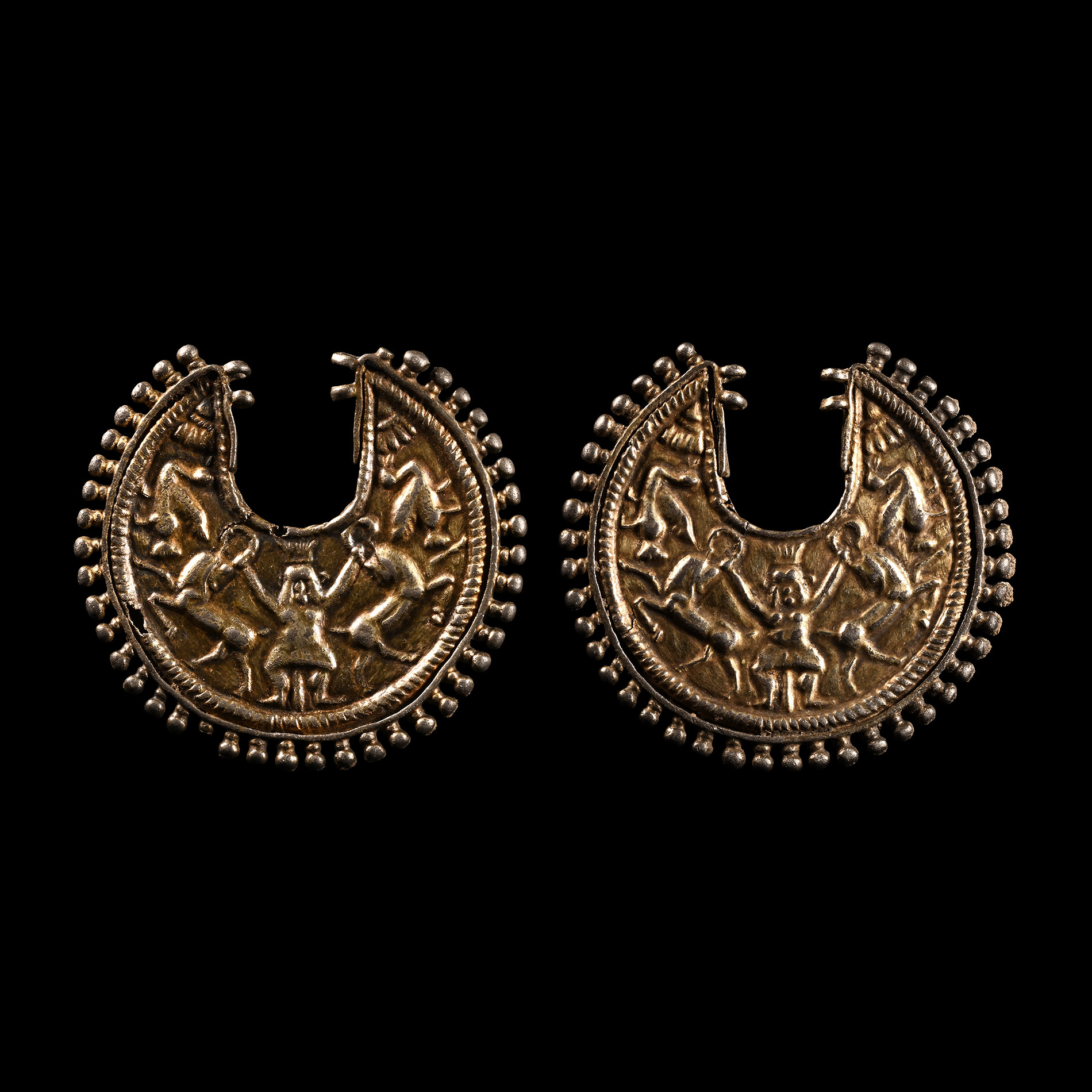 Egypto-Persian Silver-Gilt Earring Pair with Bes Holding Two Ibexes
