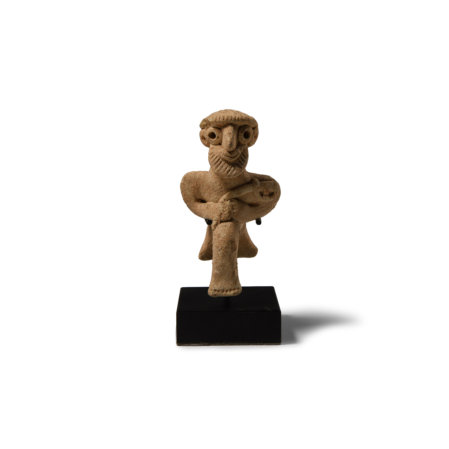 Western Asiatic Terracotta Seated Male Figure Holding an Axe