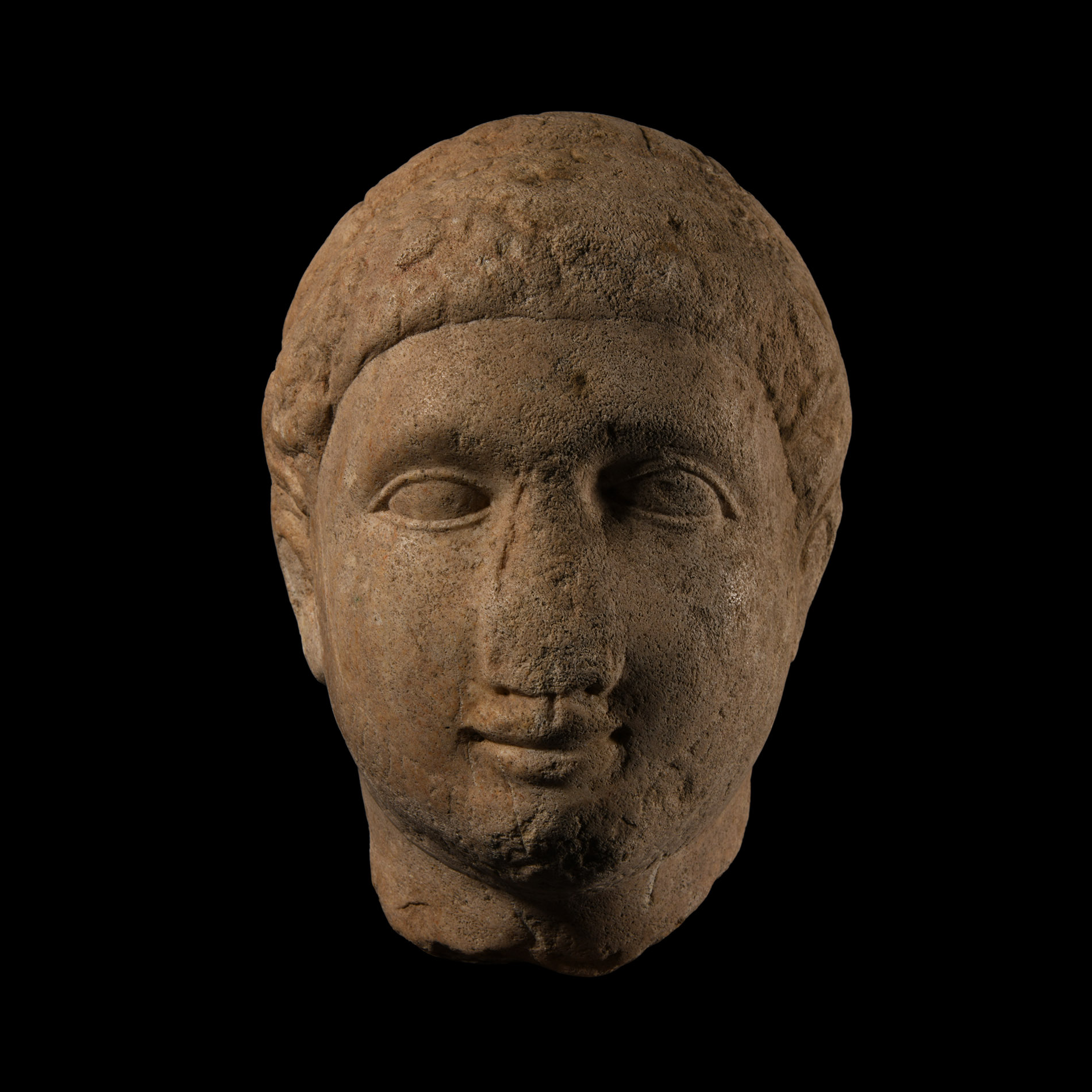 Cypriot Votive Limestone Head of a Young Man