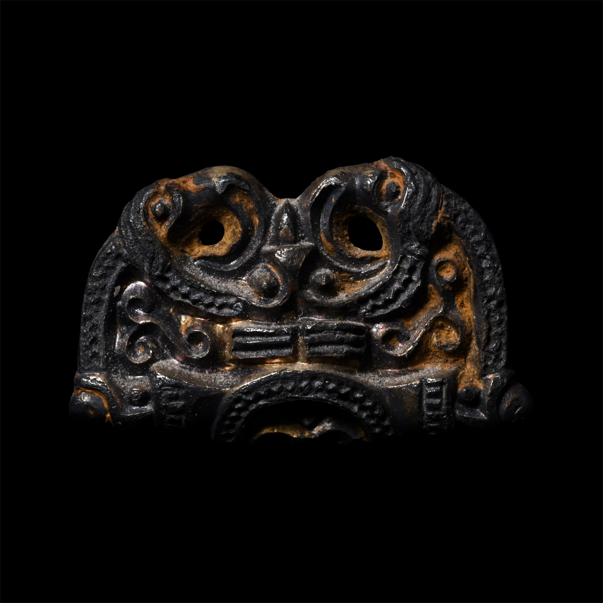 Pre-Viking Gilt Bronze Fitting with Mask Between Ravens