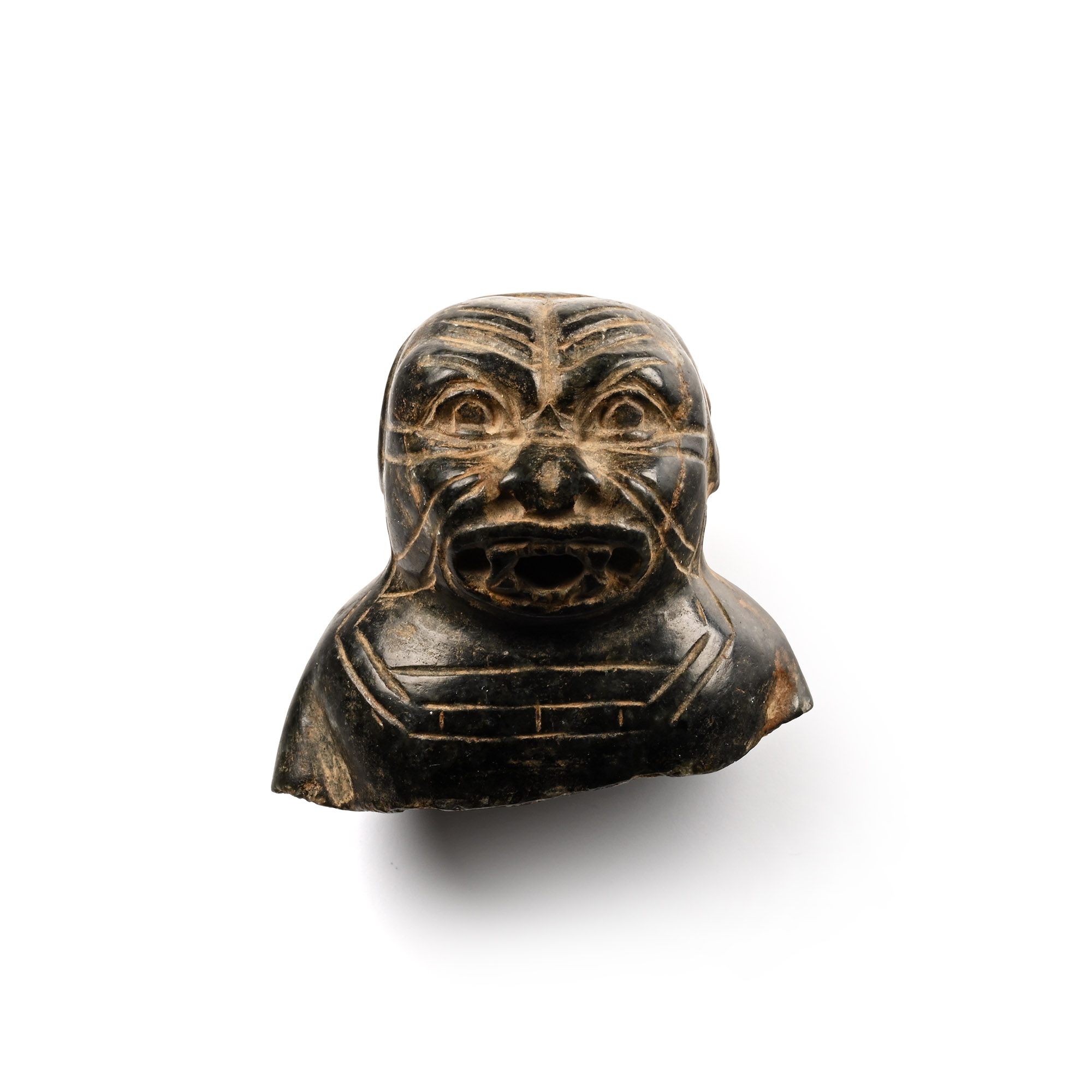 Assyrian stone bust catalogued as the demon Humbaba, hatched brow and gaping mouth