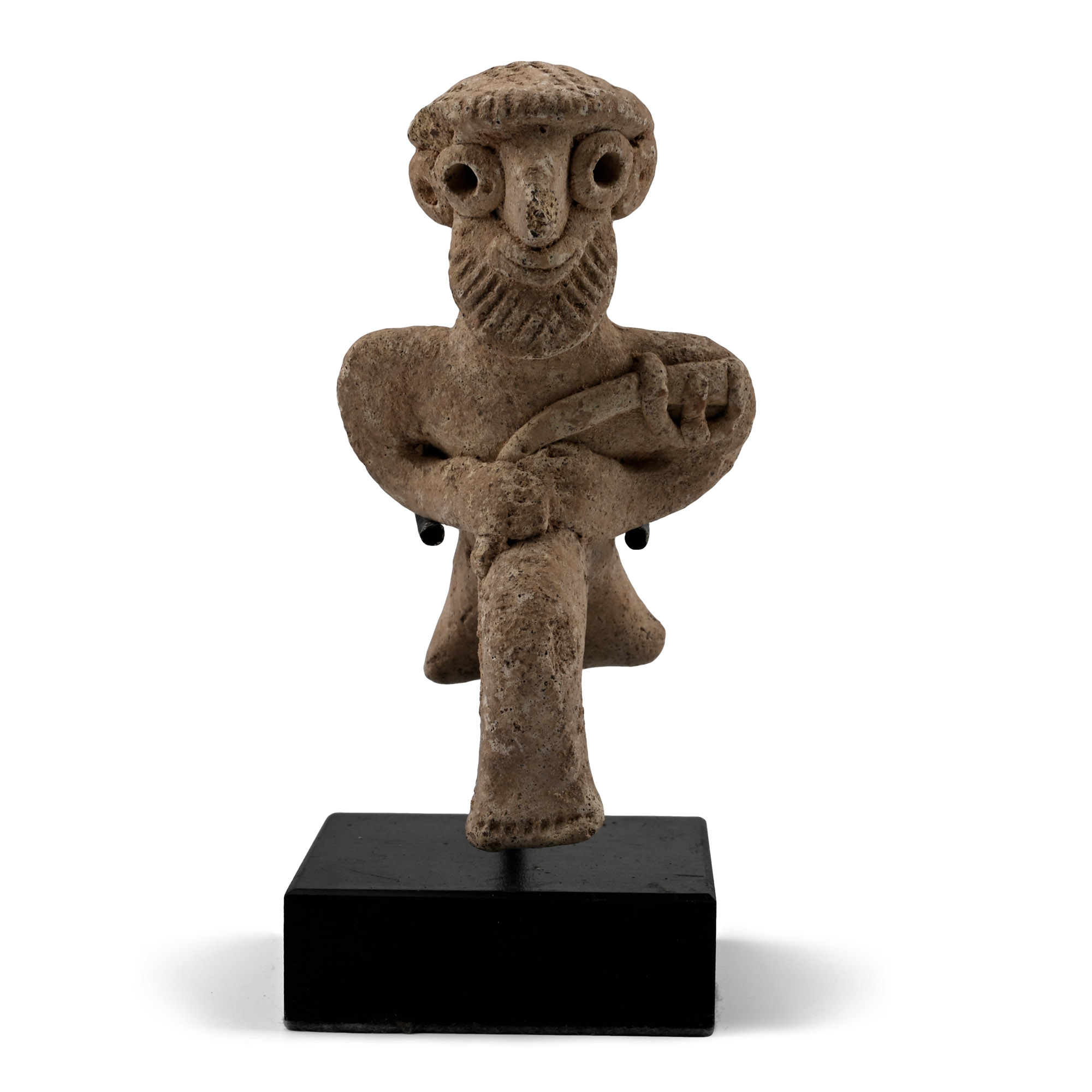 Western Asiatic Terracotta Seated Male Figure Holding an Axe