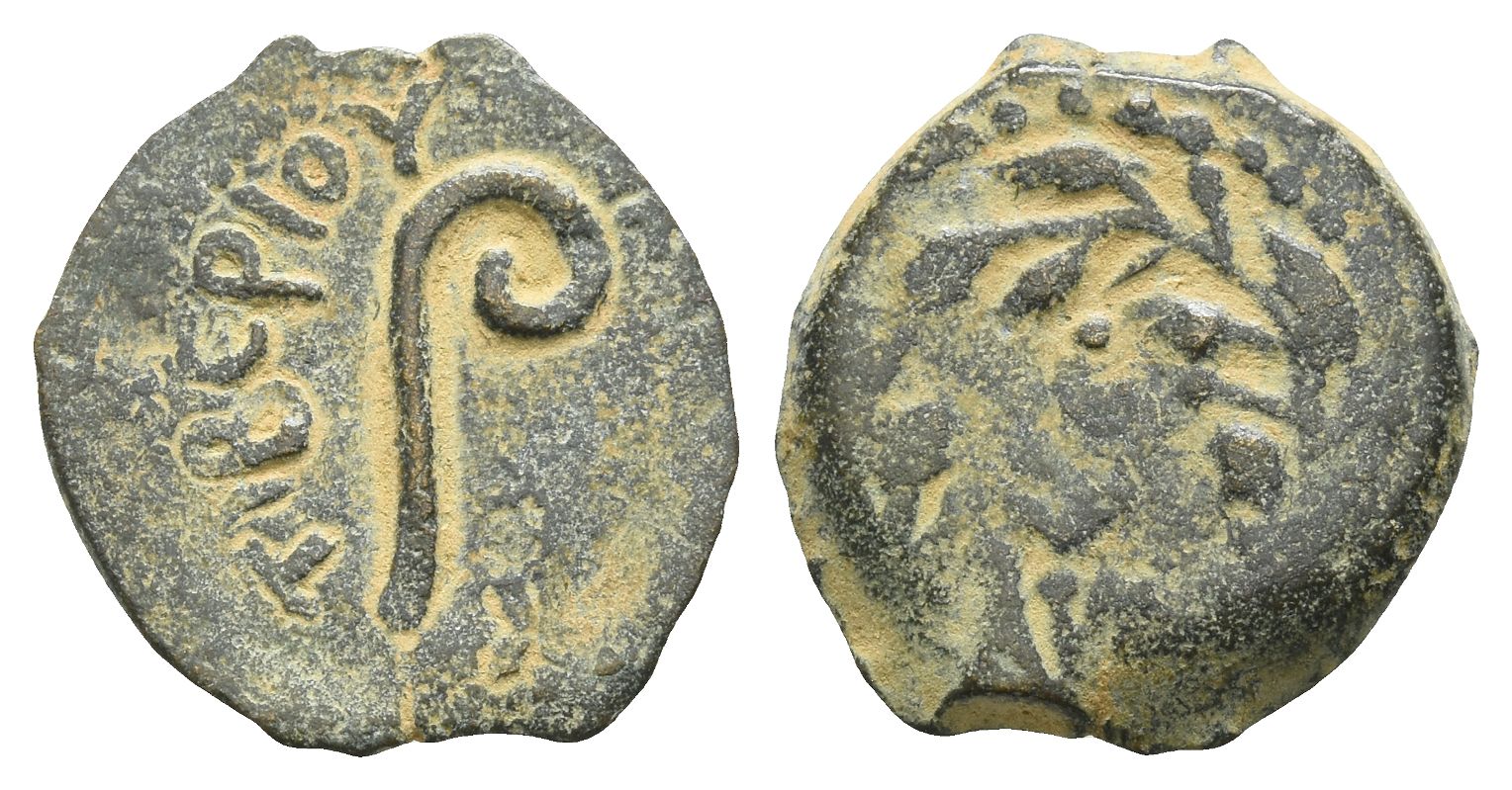 A bronze prutah of Pontius Pilate showing the augur's curved lituus, with a date in a wreath on the reverse