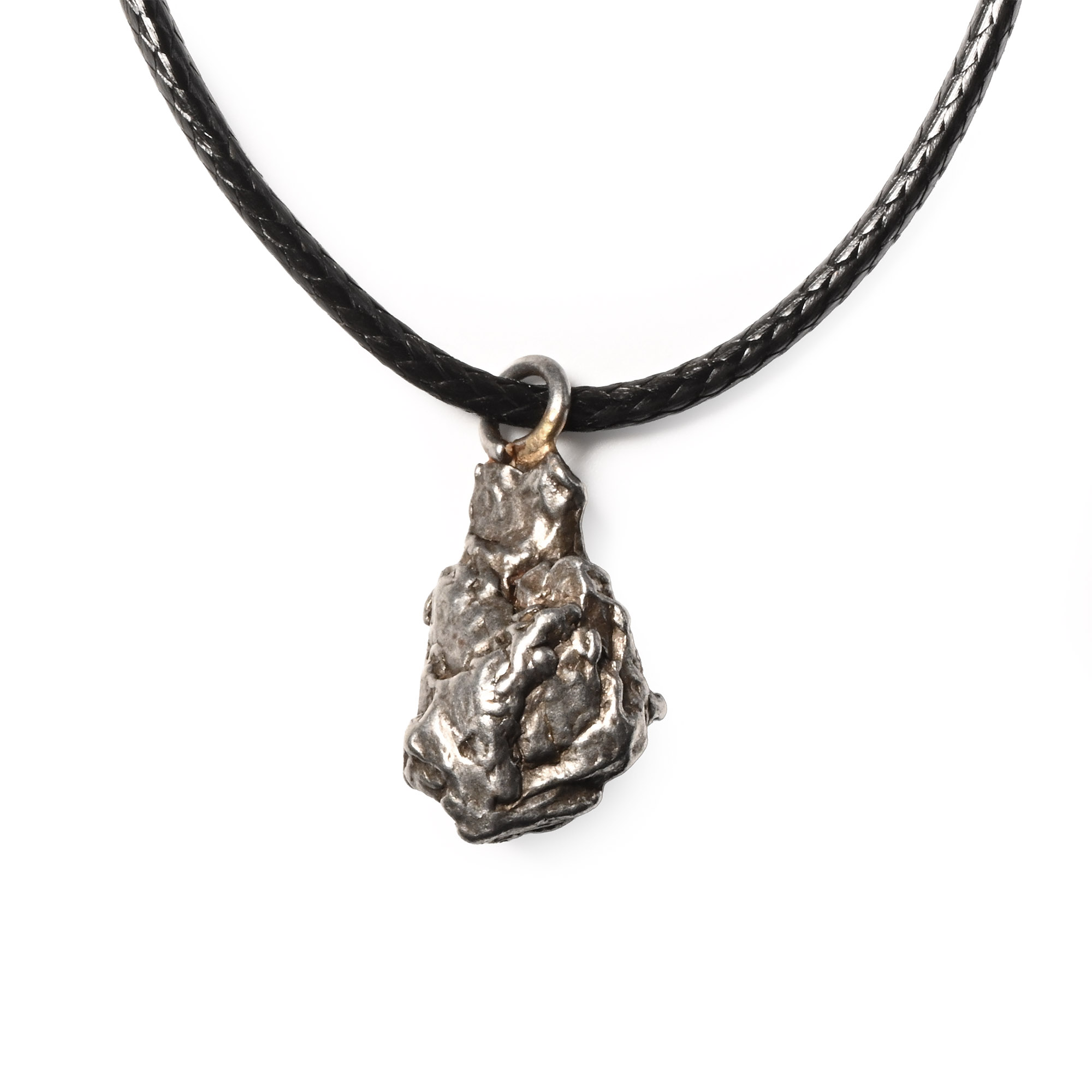 A fragment of Campo del Cielo nickel-iron meteorite mounted with a loop on a cord as a pendant