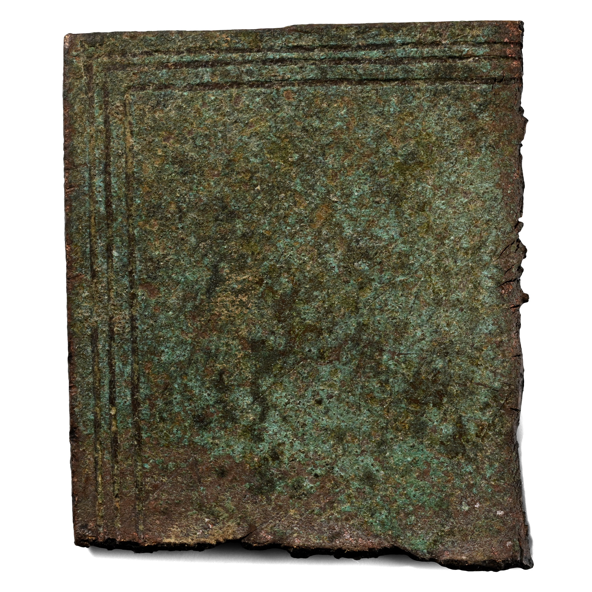 A fragment of a Roman bronze military diploma under green patina, its face ruled with concentric borders