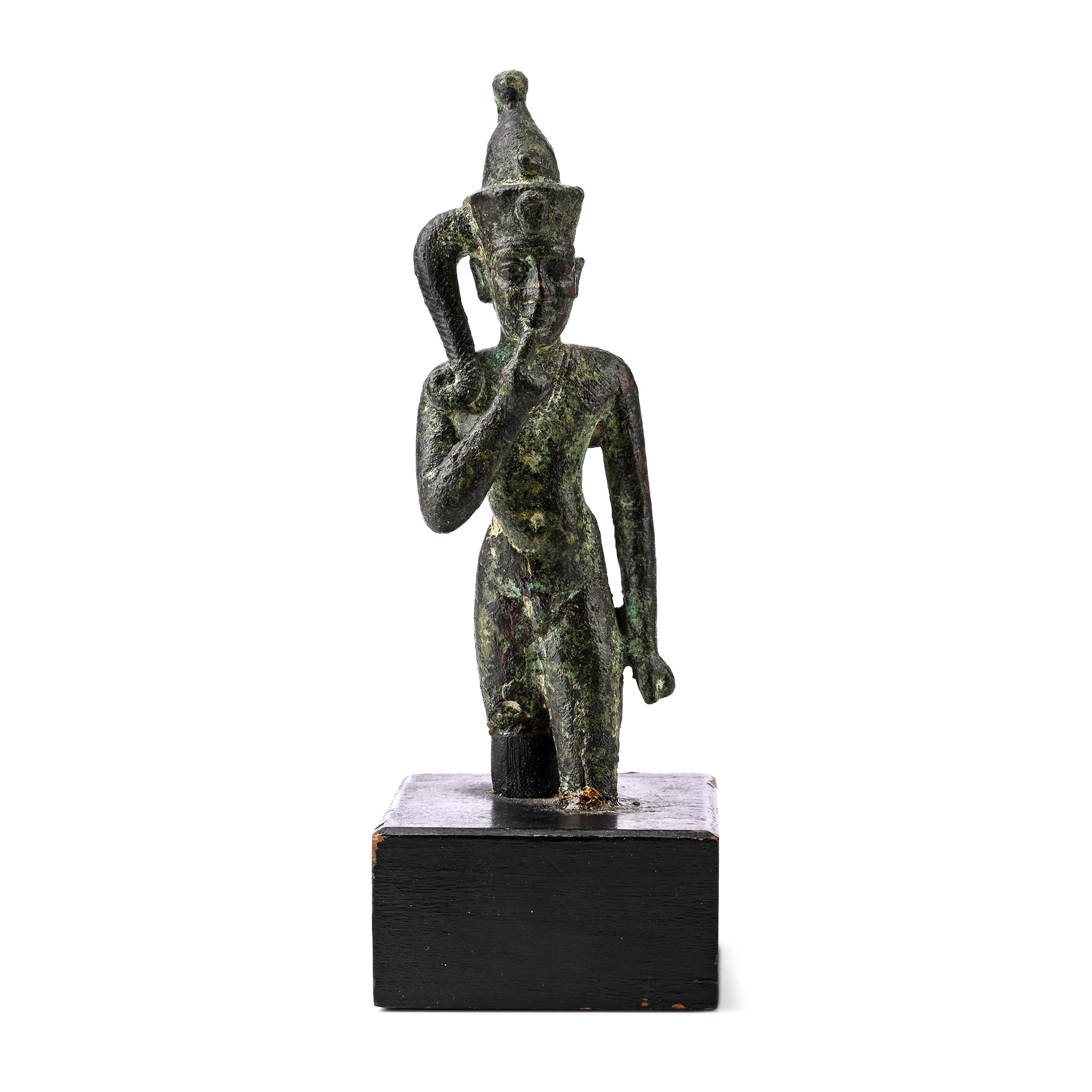An Egyptian bronze statuette of the young god Horus, striding with his right hand raised to his lips, on a wooden mount