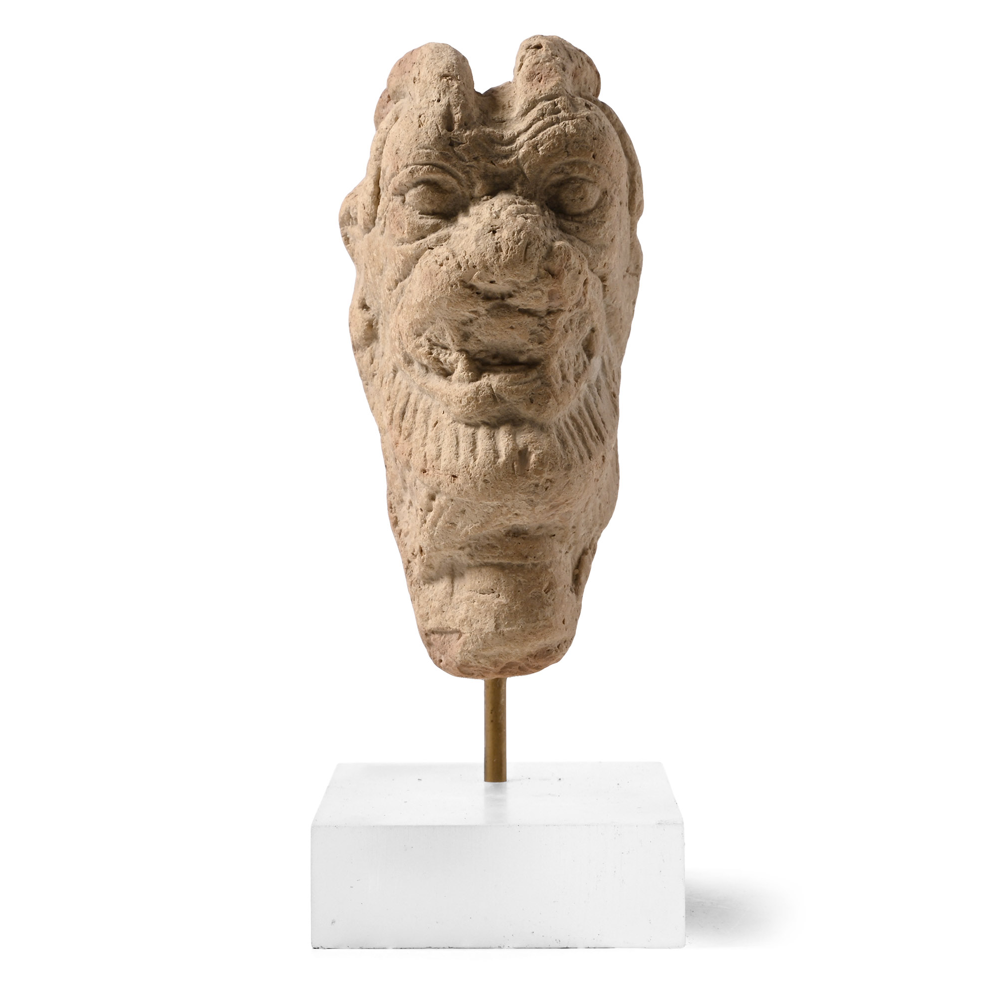 Neo-Assyrian terracotta head of the demon Pazuzu, grimacing with horns swept back