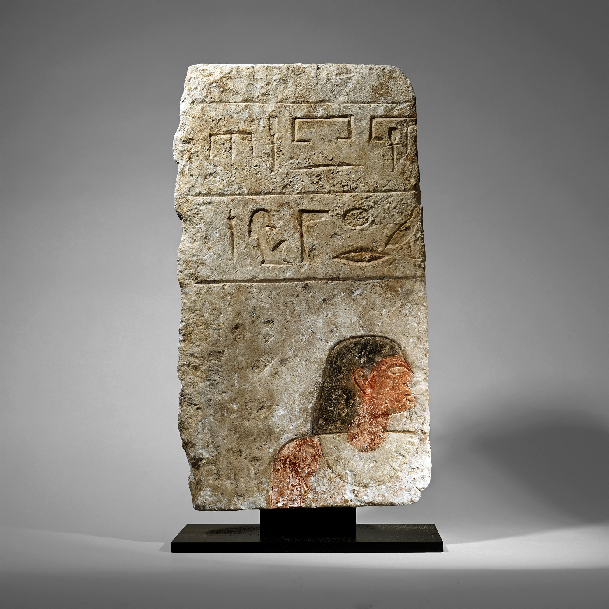 Egyptian Limestone Relief with Painted Head and Hieroglyphics