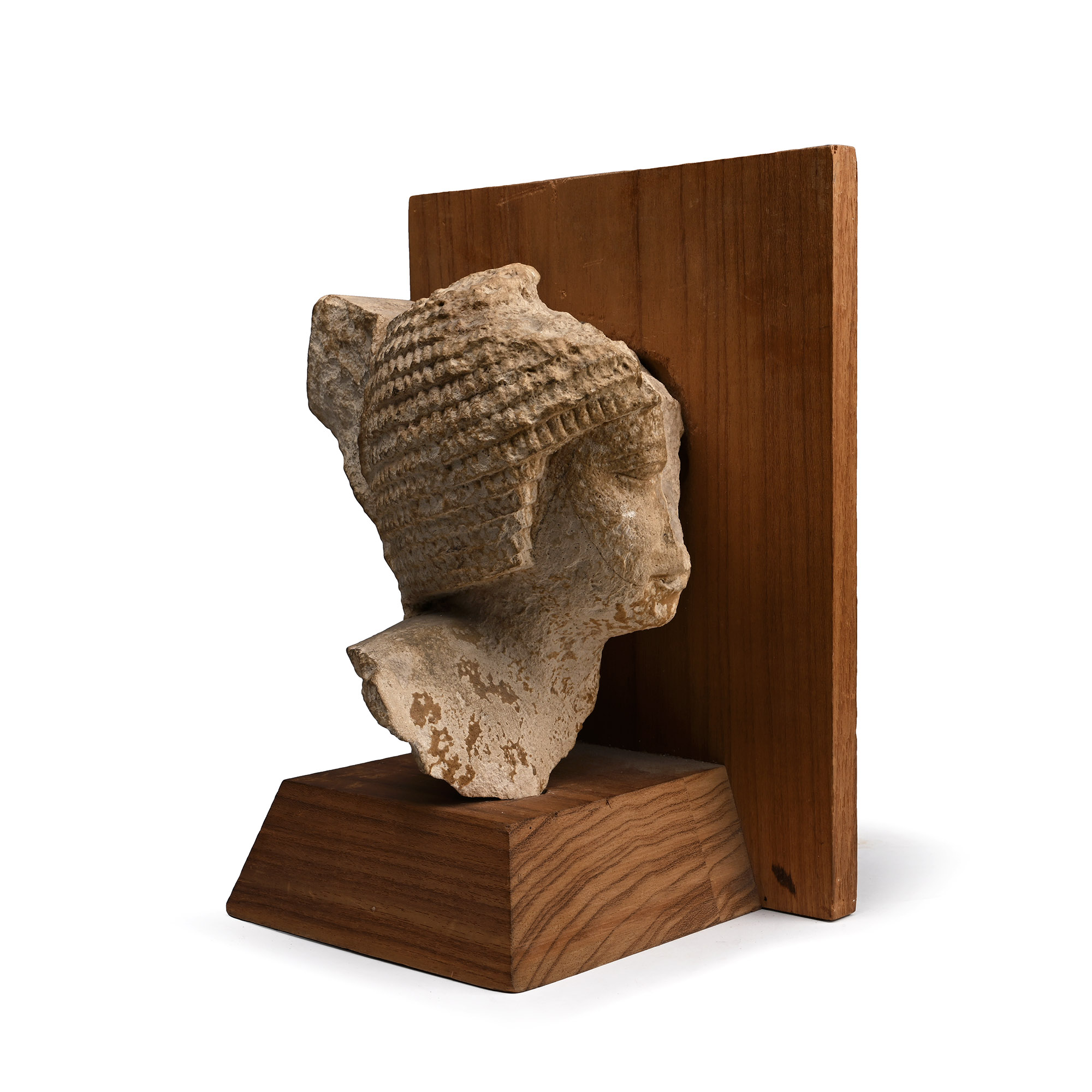 Egyptian Limestone Head of a Noble Wearing a Curled Wig
