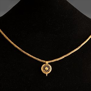Gold Necklace with Sun Whorl Pendant