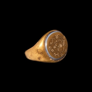 Western Asiatic Gold Ring with Bust within Grapes and Symbols