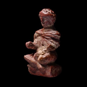 Late Roman Glass Pendant of a Seated Cloaked Male