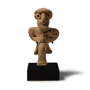 Western Asiatic Terracotta Seated Male Figure Holding an Axe