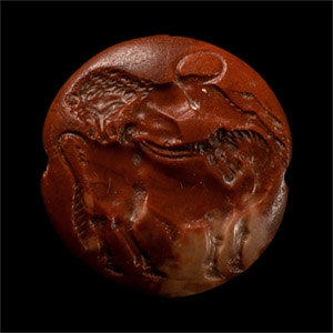 Minoan Red Jasper Seal Depicting a Lion Attacking a Bull