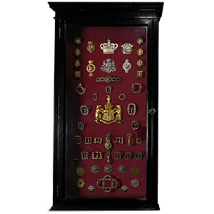 Wall Cabinet Containing an Assembly of Military and Livery Badges