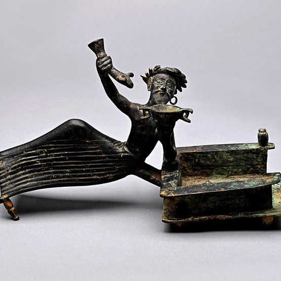 Bronze Batillum Depicting a Reclining Banqueteer with Skyphos and Rhyton