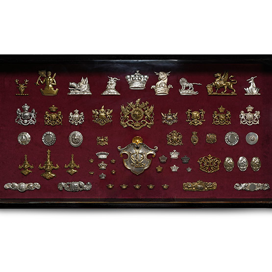 Wall Cabinet Containing an Assembly of Livery and Military Badges
