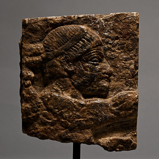 Assyrian Gypsum Relief with Head of a Bearded Man