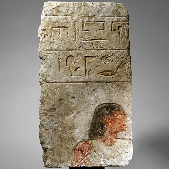Egyptian Limestone Relief with Painted Head and Hieroglyphics