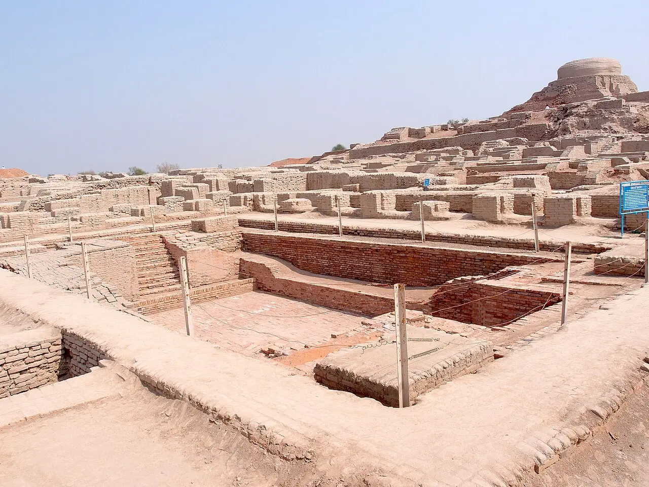 The Great Bath at Mohenjo-daro, a sunken brick tank with steps and the stupa mound behind