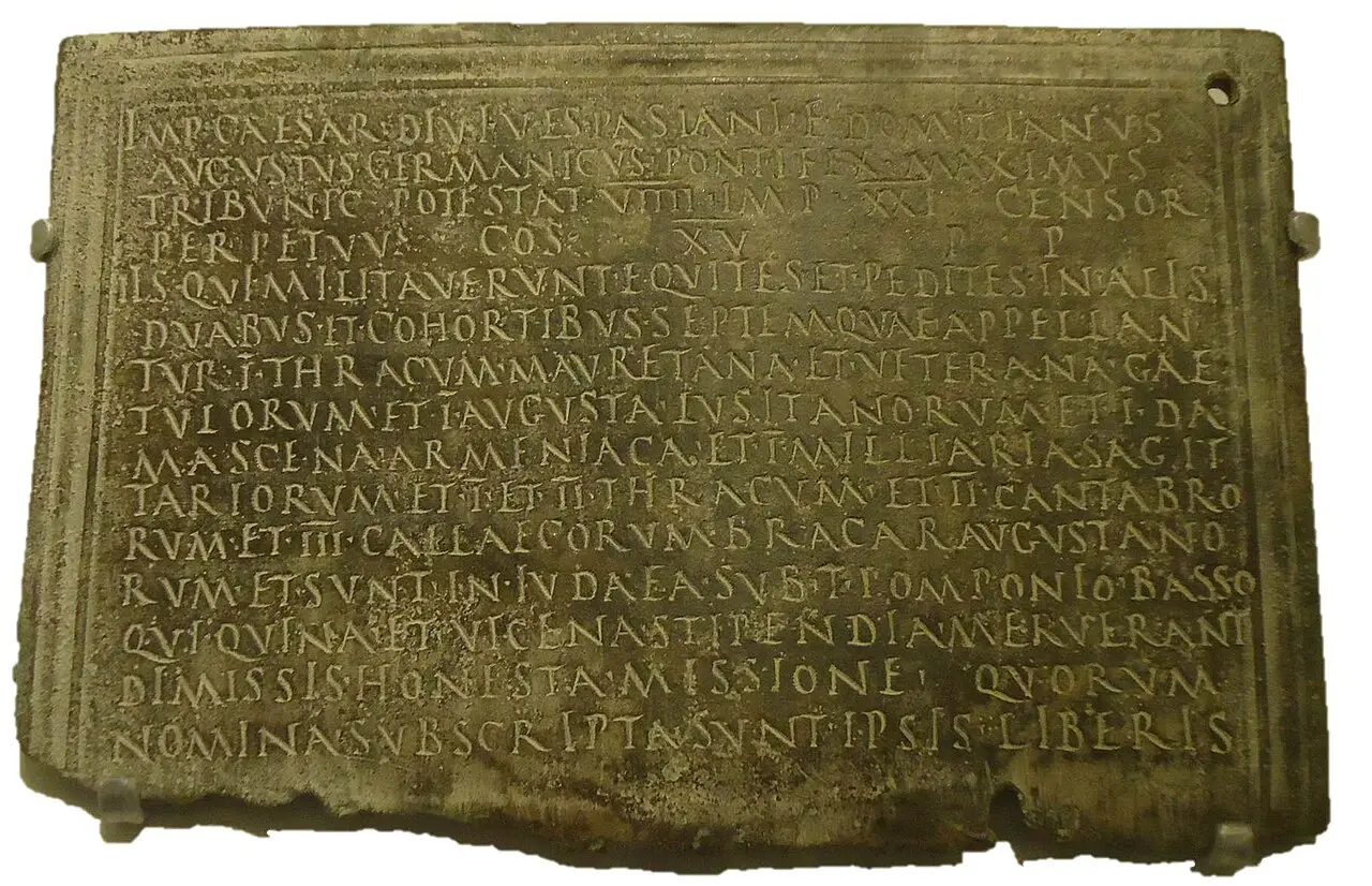 A complete Roman bronze military diploma from Judaea, its edge pierced for the binding cords