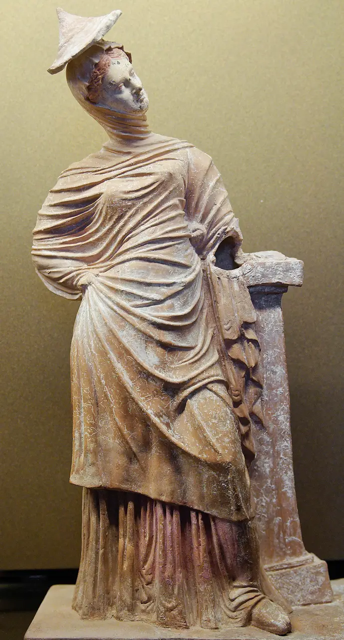 A terracotta figurine of a draped young woman from the Tanagra necropolis, now in the Louvre