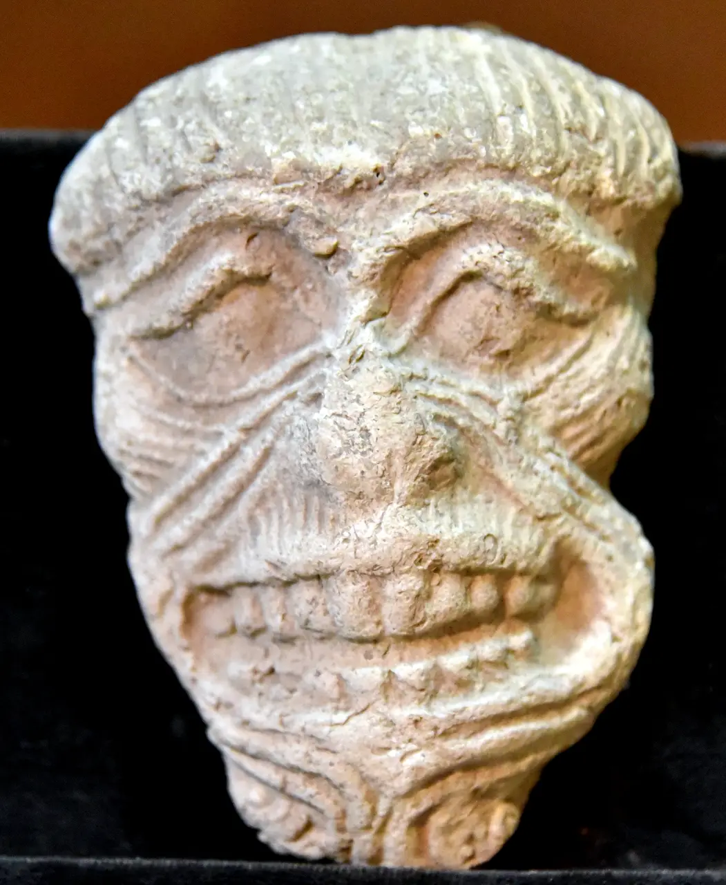 Old Babylonian terracotta mask of Humbaba, the face formed from a single coiled line