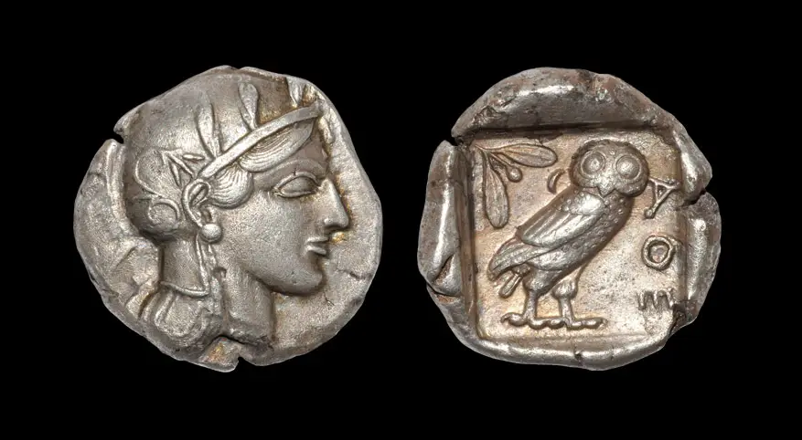 An ancient Greek silver tetradrachm of Athens, the helmeted head of Athena on the obverse and her owl on the reverse