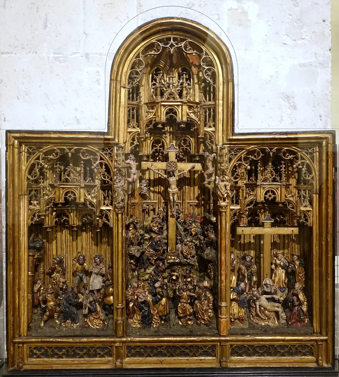 A carved and gilded oak retable of the Passion, Brussels, about 1520, with a central Calvary