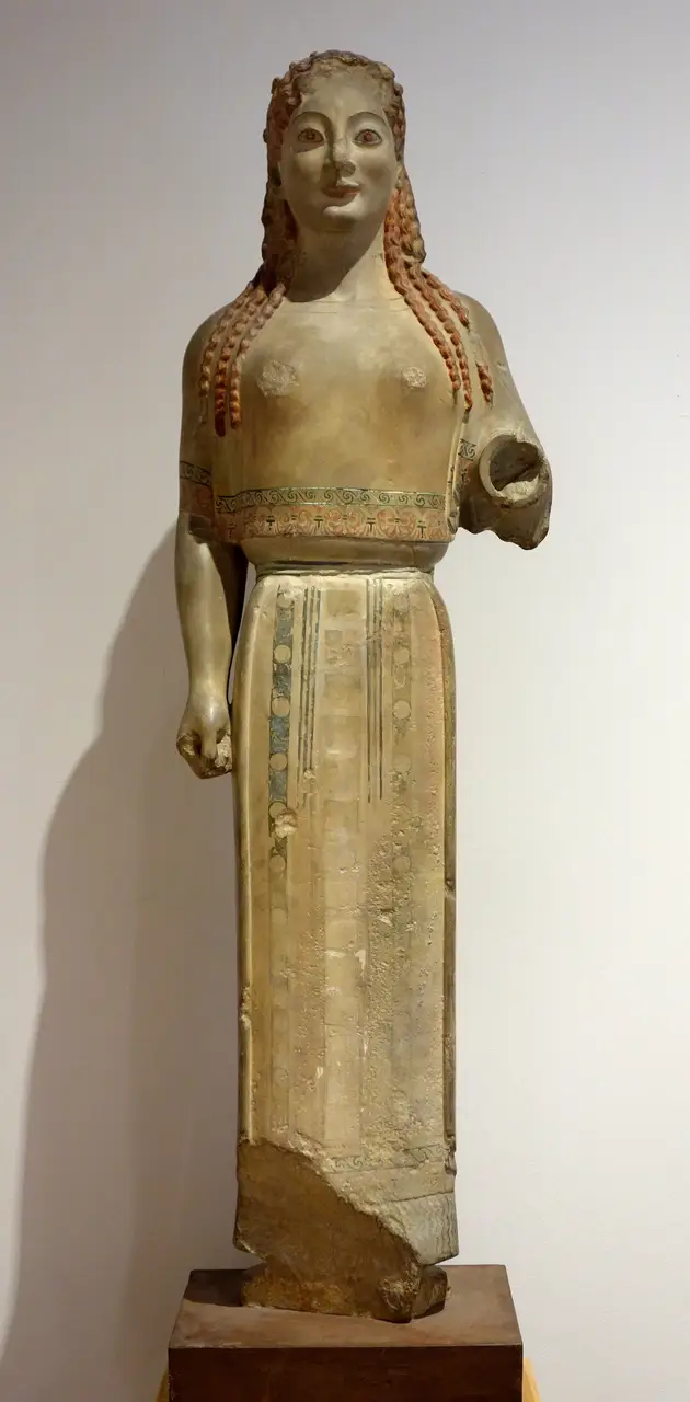 A painted plaster cast of the Peplos Kore, red hair and a patterned dress restored