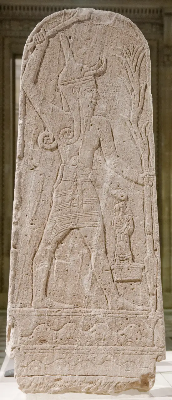 The "Baal au foudre" stele from Ugarit, showing the storm-god striding with a raised club and a lightning-shaped spear, in the Louvre