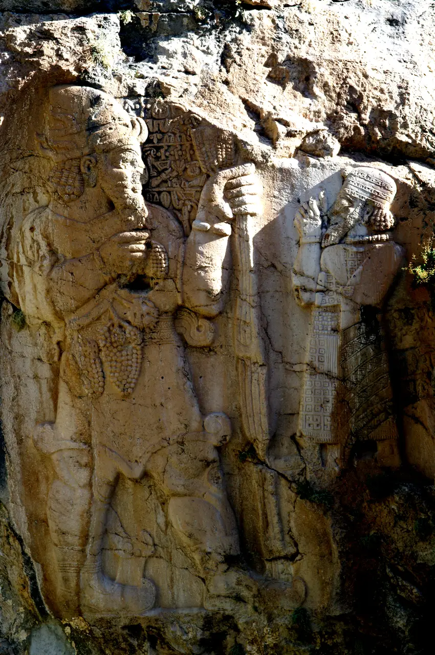 The İvriz rock relief showing King Warpalawas in prayer before the Luwian storm-god Tarhunza, who holds out ears of grain and a bunch of grapes