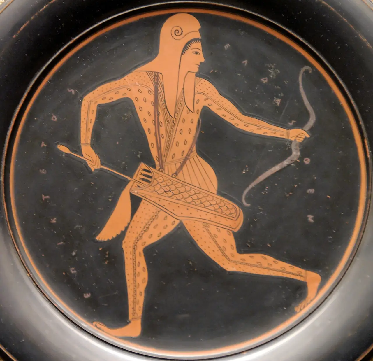 A running archer in Scythian costume on a plate signed by Epiktetos