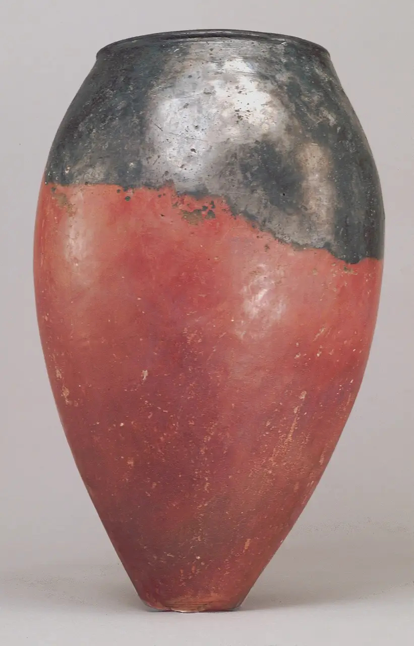 A black-topped red ware jar with ovoid body and pointed base, excavated at Hierakonpolis, in the Metropolitan Museum of Art