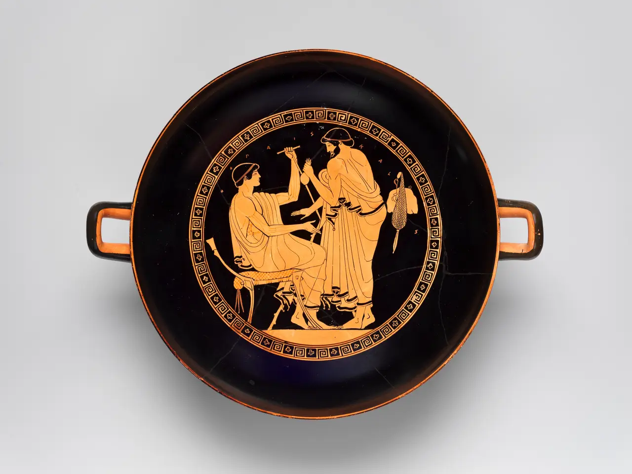 Ancient Greek red-figure kylix depicting a courtship scene between