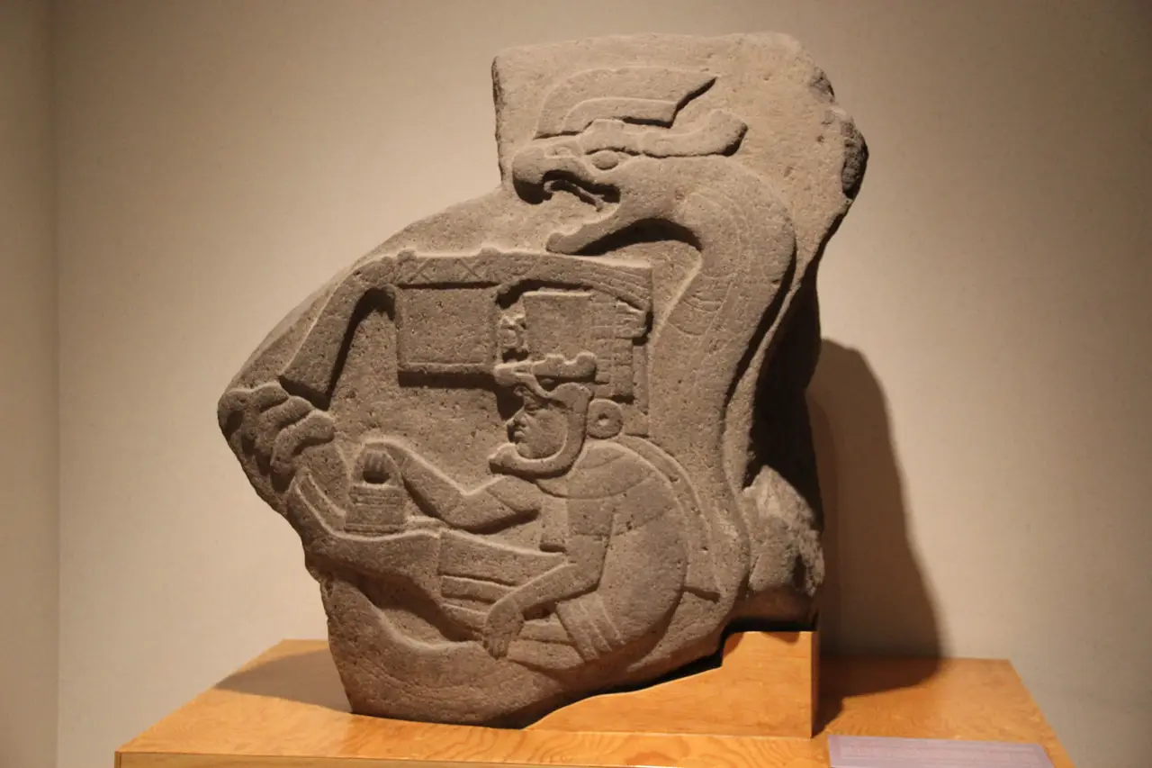 La Venta Monument 19, an Olmec relief of a figure enclosed by a rattlesnake, holding a small pouch