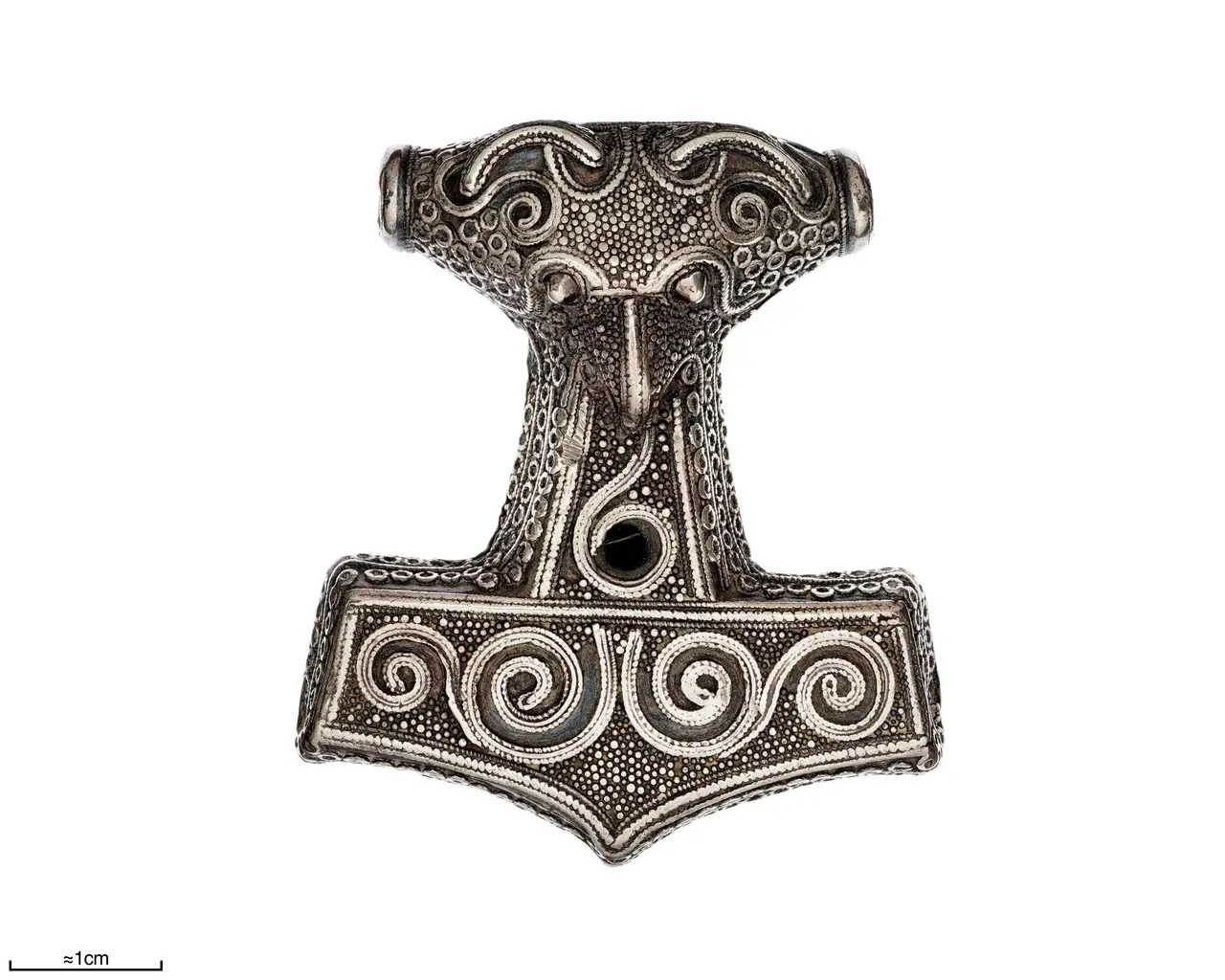 A silver filigree Thor's hammer from Skåne with a beast-head at the suspension bar