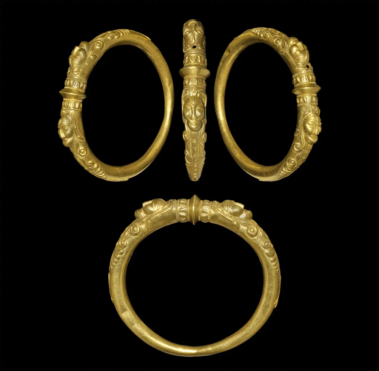 An Iron Age Celtic gold armring ornamented in relief with facing human heads
