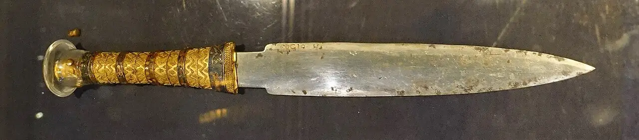 The gold-hilted iron dagger of Tutankhamun, laid horizontally