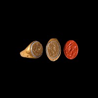 Western Asiatic Gold Ring with Bust within Grapes and Symbols