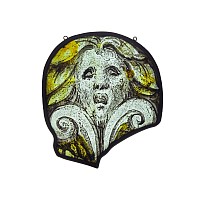 Medieval Ovoid Stained Glass Panel Depicting a Grotesque Mask