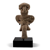 Western Asiatic Terracotta Seated Male Figure Holding an Axe