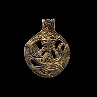 Viking Age Silver-Gilt Gripping Beast Pendant