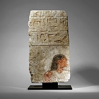 Egyptian Limestone Relief with Painted Head and Hieroglyphics