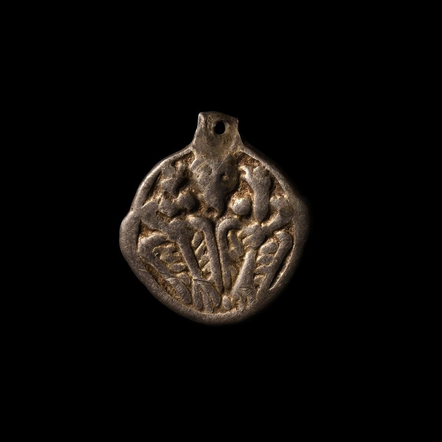 Viking Silver-Gilt Pendant with Odin Gripping Two Ravens